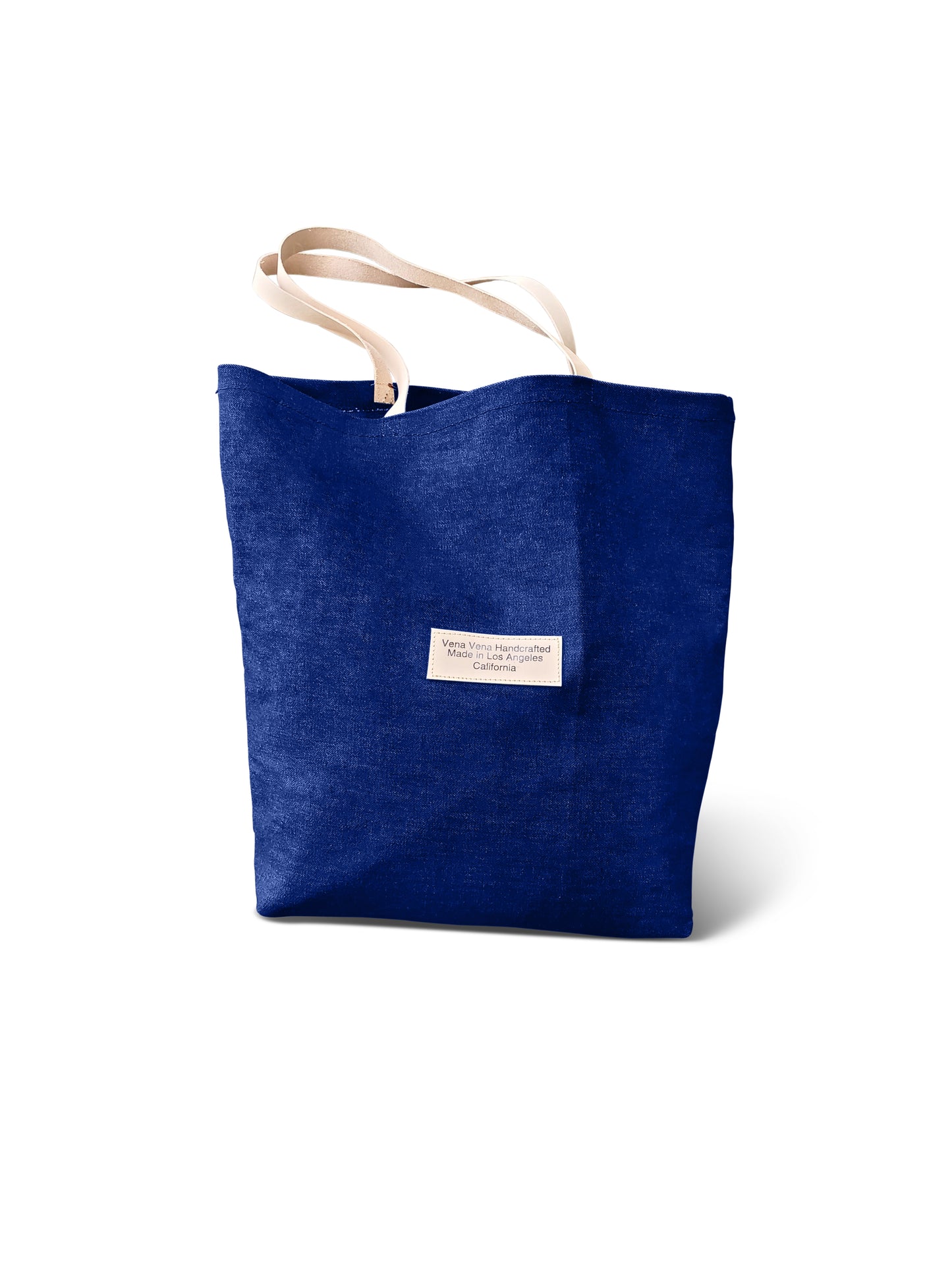15 inch denim tote bag with natural leather straps & double inside pockets. Made in LA