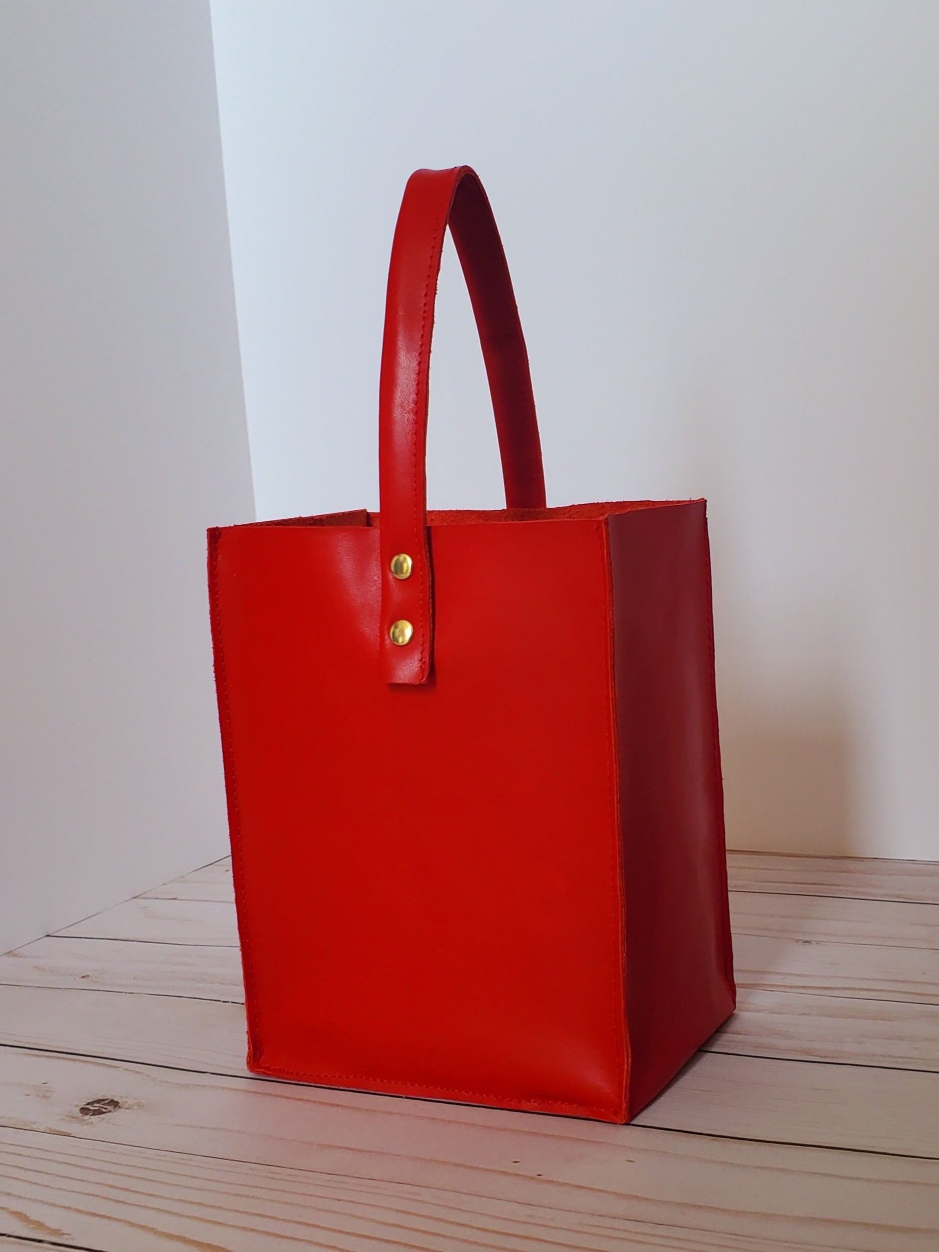 Red leather square bag with 1 handle. Made in Los Angeles,California