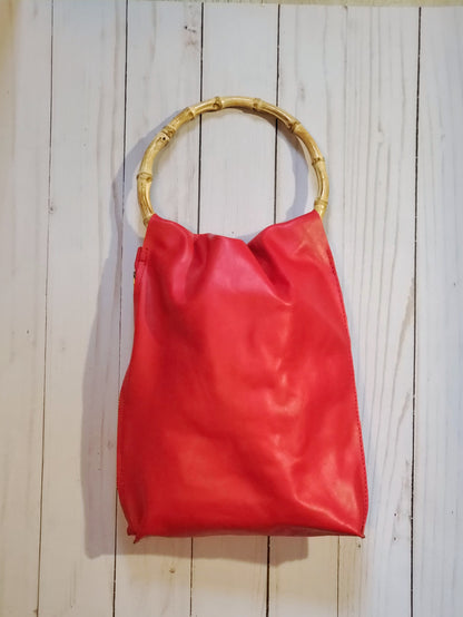 4 inch round bamboo handle leather bag in red, it has a side zipper