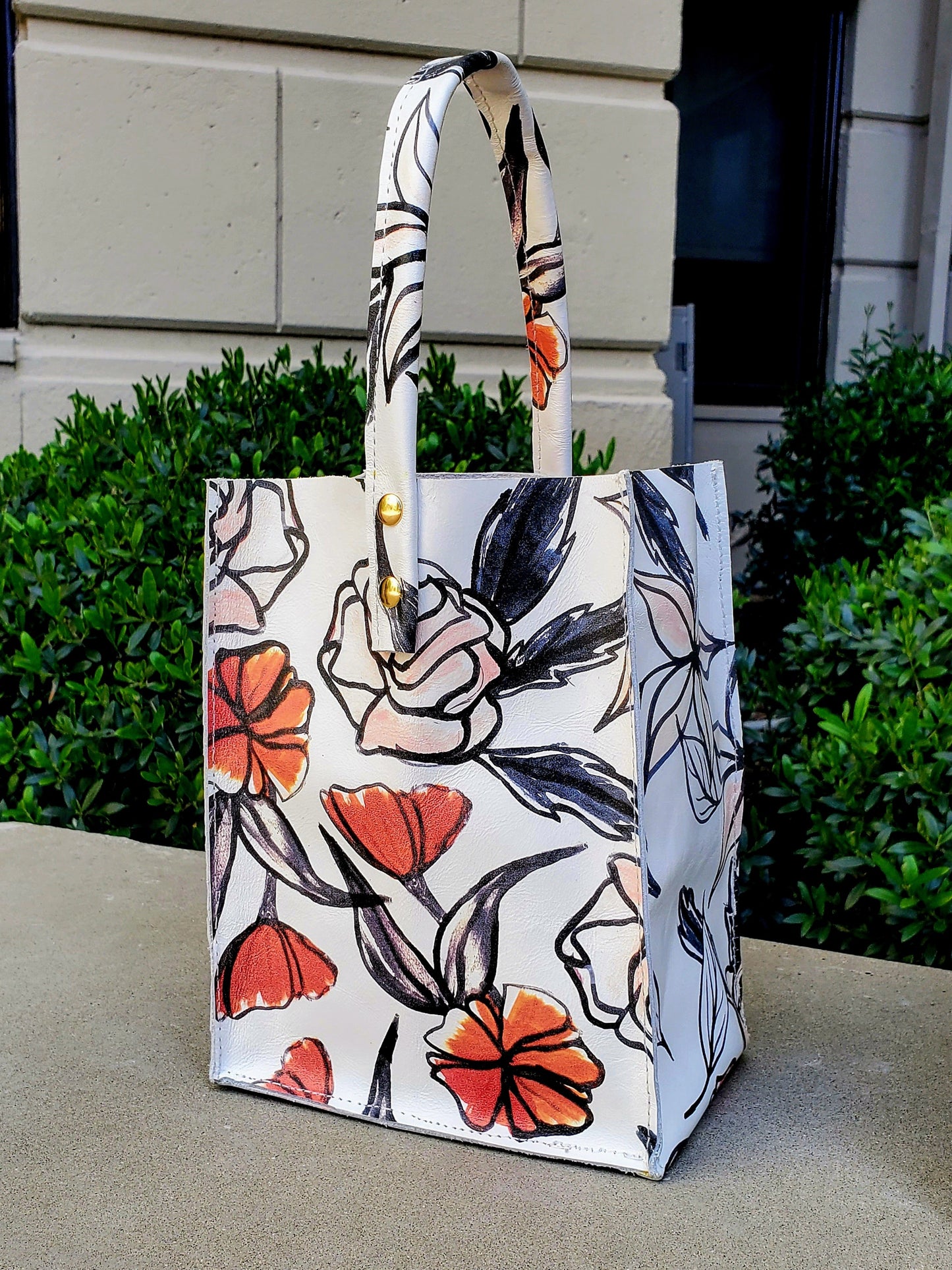 Leather Square bag in white,red,black flowers with 1 handle. Handcrafted in Los Angeles, California 