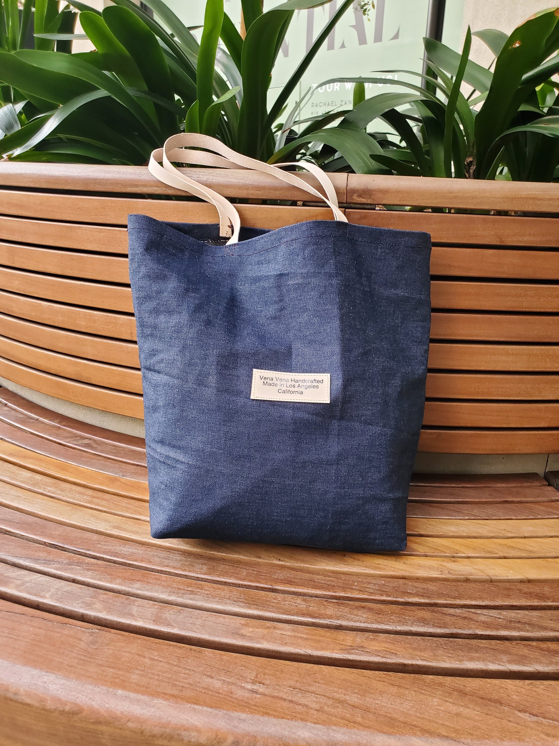 Denim tote bag with natrural color leather straps. Made in Los Angeles