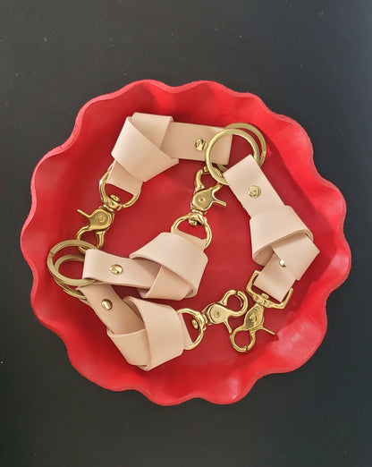 Natural leather Keychains in a red leather tray made in LA