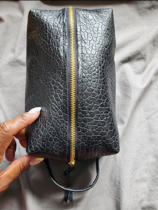 Black leather dopp kit with gold zipper & rivets. Handcrafted in Los Angeles,California