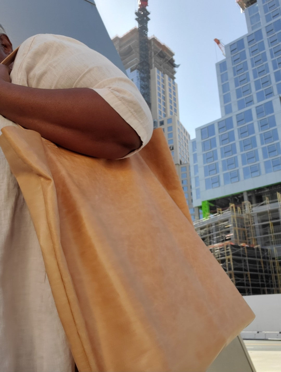 Woman with the beige tote bag on her shoulder