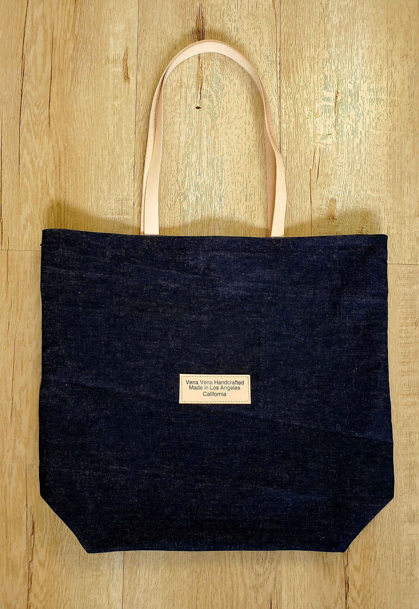 Dark denim tote bag with leather straps handmade in Los Angeles California