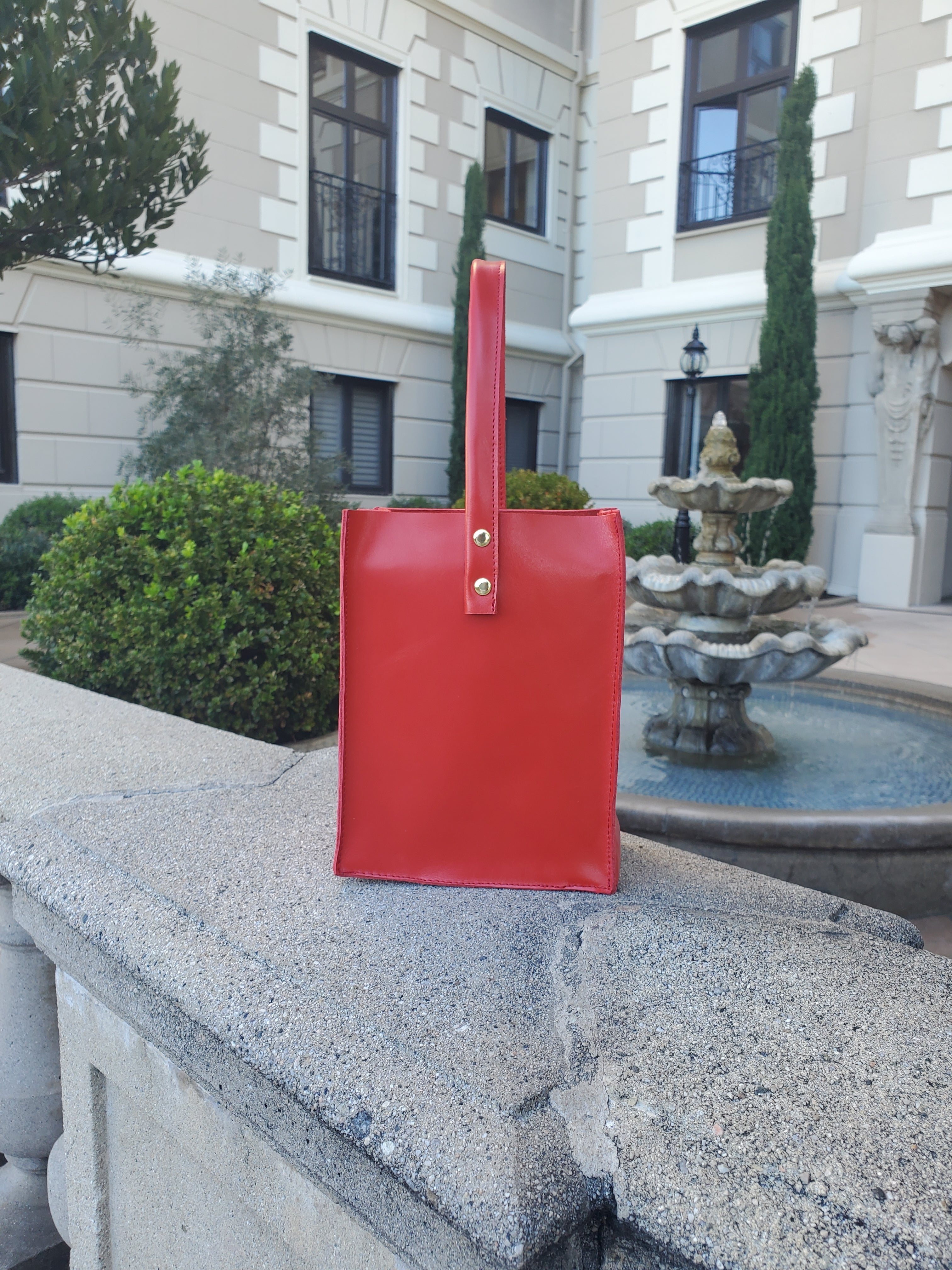 Red leather square bag with 1 handle. Made in Los Angeles California. 